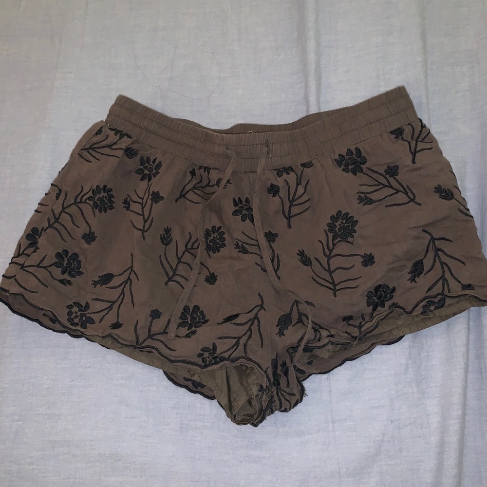 Olive green shorts with black floral embroidery